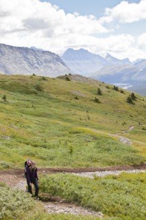 Caucasian mother and baby on path in mountain landscape
