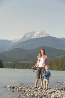 Caucasian mother and son fishing in remote lake