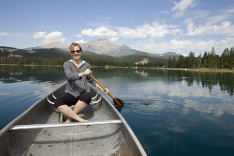 Caucasian woman paddling in kayak