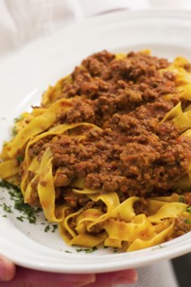 Close up of meat ragu over noodles