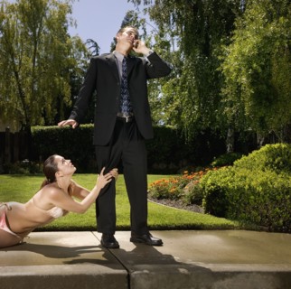 Hispanic woman in bikini grabbing businessman's leg