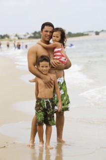 Father with daughter and son on beach