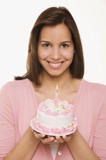 Hispanic woman holding birthday cake