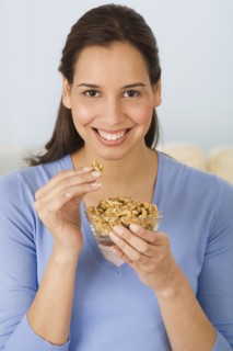 Hispanic woman eating walnuts