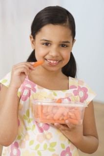 Hispanic girl eating carrots