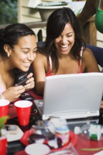 Friends looking at laptop