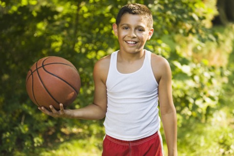 Mixed race boy holding basketball