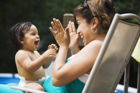 Hispanic mother playing with baby boy