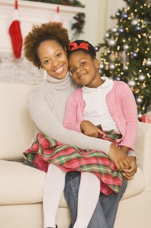 African mother hugging daughter at Christmas