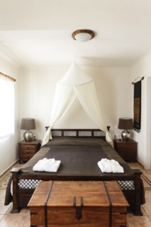 Chest near wooden bed in bedroom