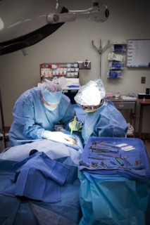Surgeons operating on patient in hospital