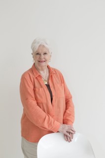 Portrait of smiling Caucasian woman leaning on chair