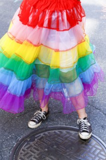 Person wearing rainbow skirt