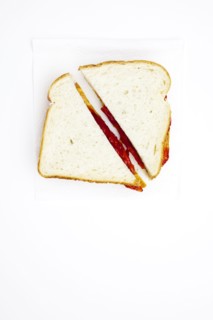 One peanut butter and jelly sandwich cut in half