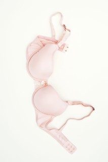 Pink bra laying on ground