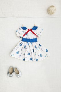 Girl's dress and shoes hanging on wall