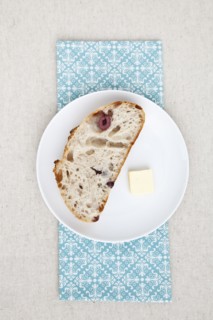 Olive bread and butter on plate