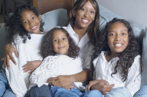 African American mother with daughters smiling