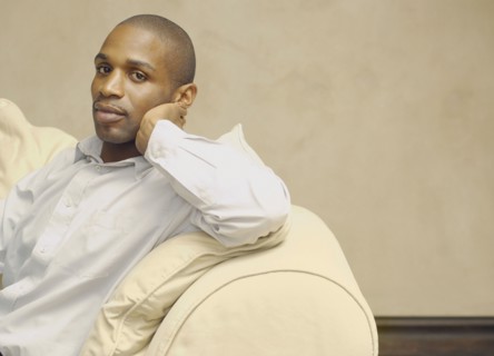 African American man sitting on sofa