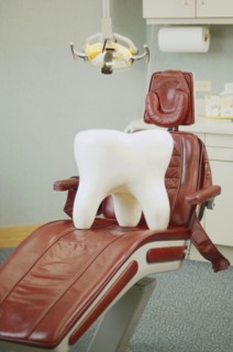Giant tooth sitting on dentist's chair
