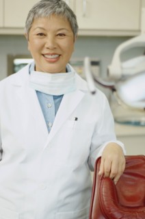 Senior Asian female dentist smiling