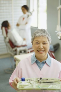 Senior Asian female dental assistant smiling