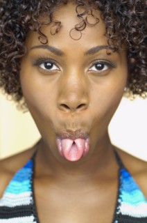 Close up of African woman sticking out tongue