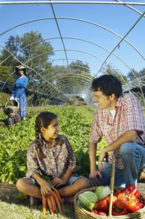 Multi-ethnic father and daughter with organic produce