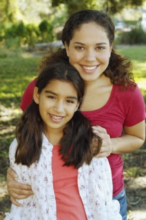 Hispanic mother and daughter hugging