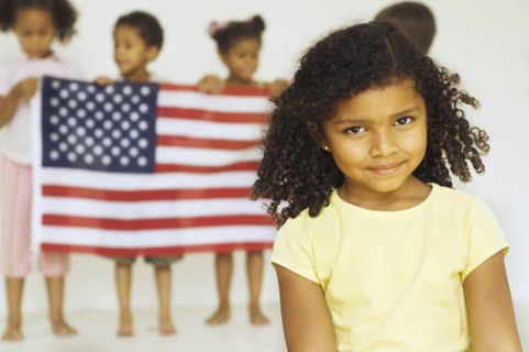 Multi-ethnic children holding American flag