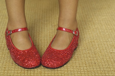 Close up of mixed race girl wearing red shoes