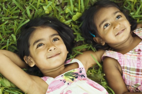 Indian girls laying in grass
