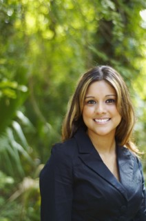 Hispanic businesswoman posing outdoors