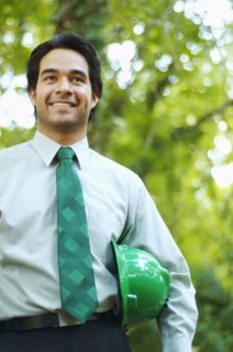 Hispanic businessman with green hard hat