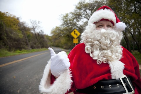 Santa hitchhiking at roadside