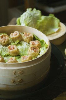 Asian dumplings in steamer with cabbage