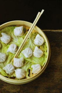 Asian dumpling in steamer with cabbage