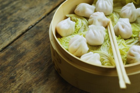 Asian dumpling in steamer with cabbage