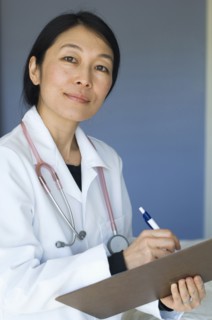Japanese doctor writing on clipboard
