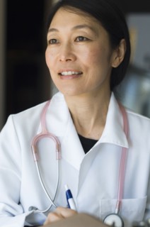 Japanese doctor writing on clipboard