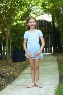 Hispanic ballerina standing outdoors