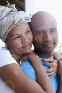 Mixed race couple hugging outdoors
