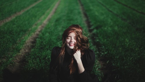 Smiling Caucasian woman in rows of grass