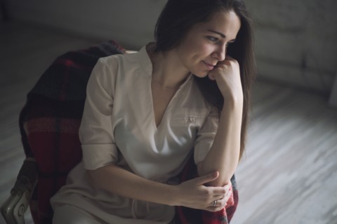 Pensive Caucasian woman sitting in chair