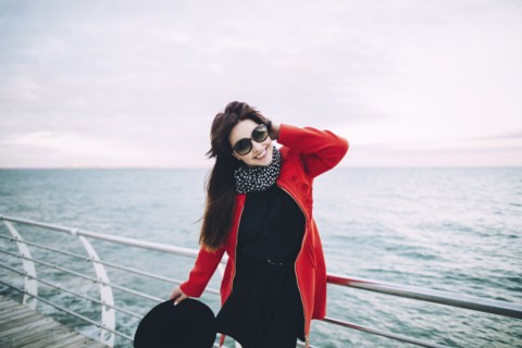 Portrait of smiling Caucasian woman standing on boardwalk