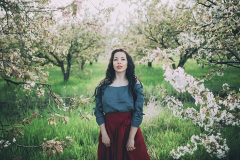 Caucasian woman standing near flowering trees