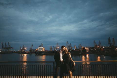 Caucasian couple hugging at waterfront