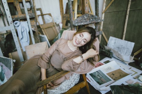 Smiling Caucasian woman laying in chair