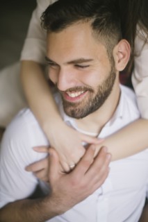 Caucasian woman hugging smiling man