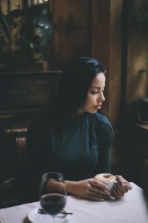 Pensive Caucasian woman drinking coffee